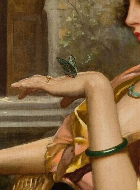 A hand releasing a butterfly, a jade bangle at the wrist